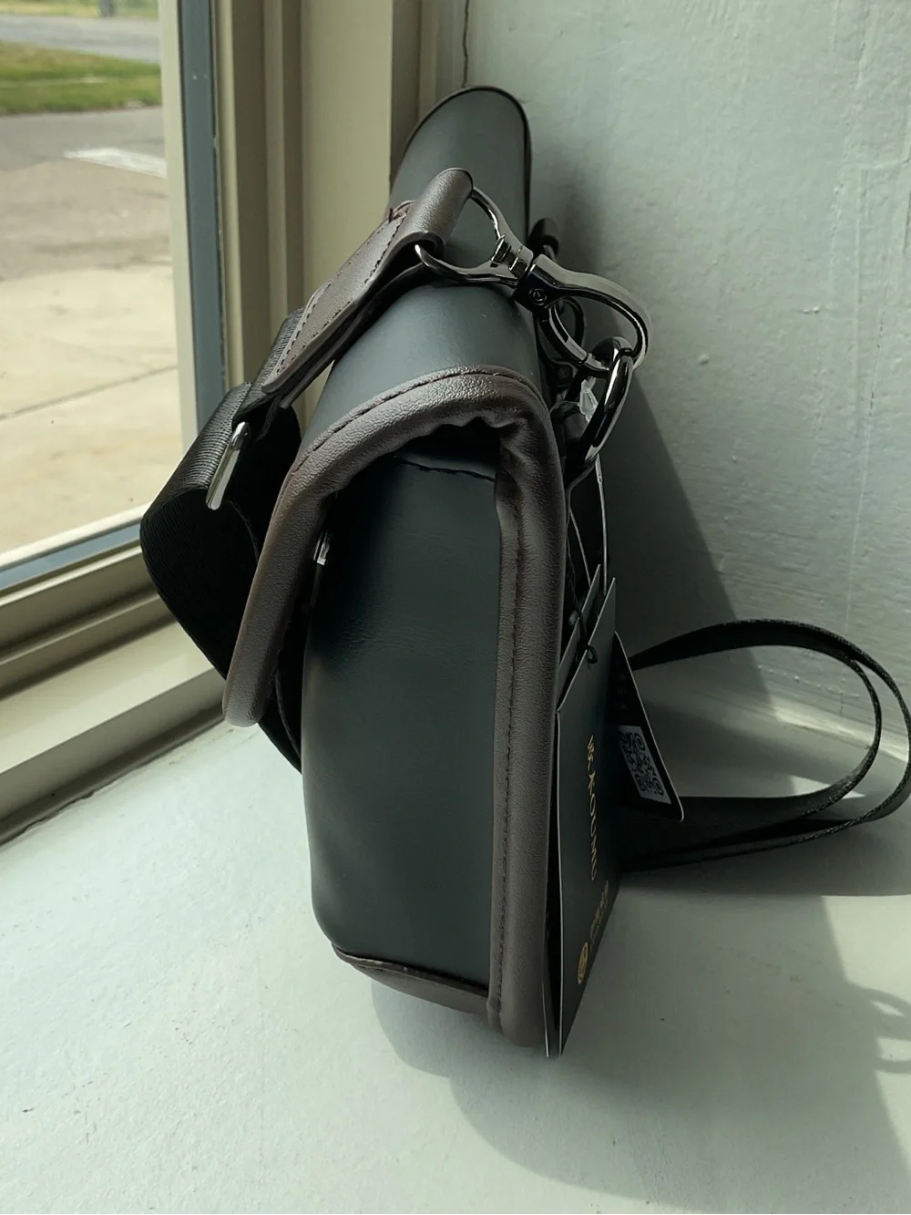 Black Crossbody Bag with Brown Trim and Adjustable Strap